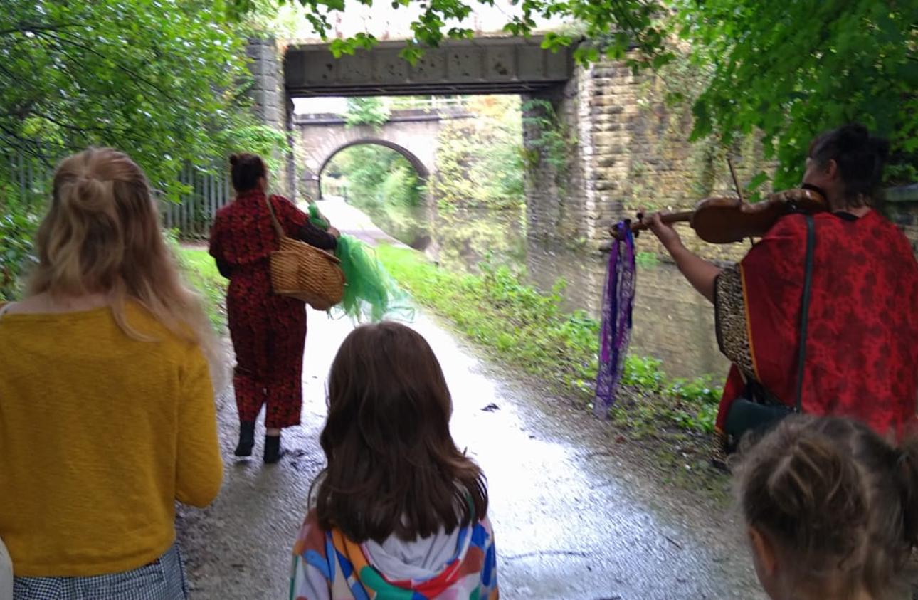 A photograph of the performance along the side of the canal