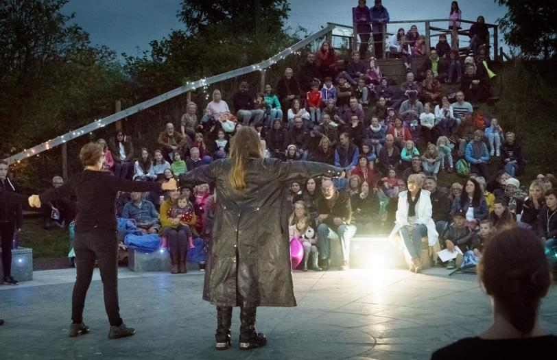 A storyteller performing in front of an audience.