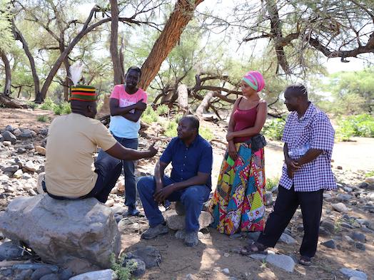 From left: Abdi Achegei Adan, the Director of Elemi Development Organization, John Namai (a storyteller) Calistus Wachana (ICPAC User Engagement Expert), Mara Menzies (a storyteller) and Francis Muinda (Turkana County Meteorological Services Director) during an interview at the Lokiriama Peace Accord Commemoration in Lokiriama village, Turkana County, Kenya