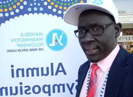 a young black man with glasses and a white baseball cap